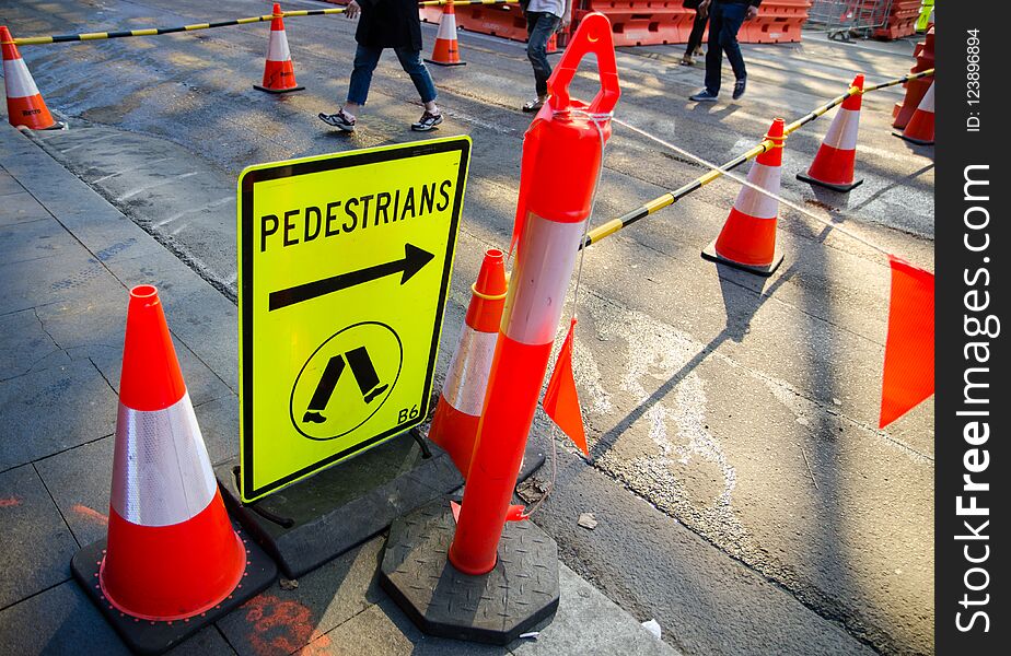 Pedestrian signs near construction site for indicating people.