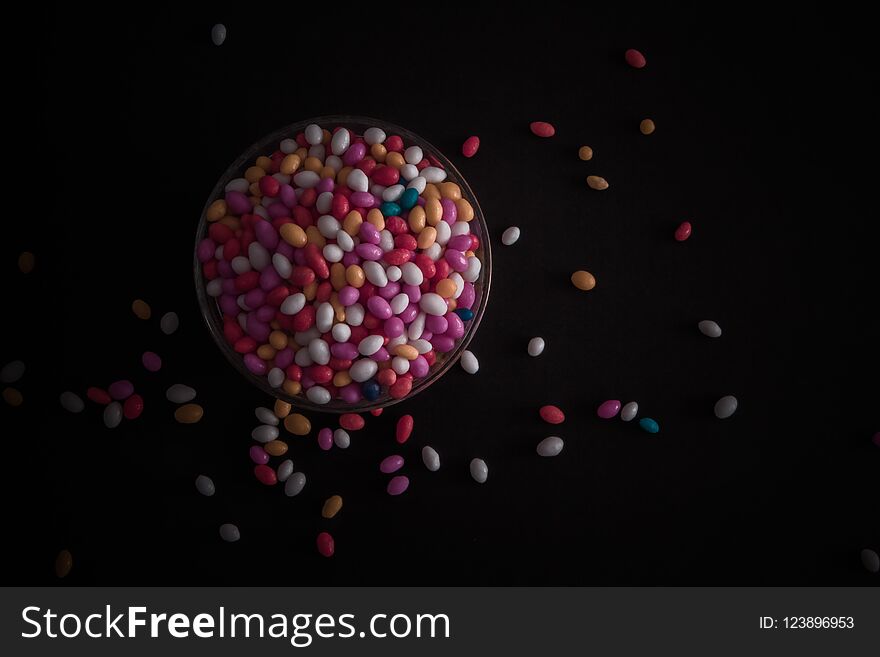 A cup Full of Sugar Coated Colorful Fennel Seeds with red, Orange, Yellow, Blue White Colors. A cup Full of Sugar Coated Colorful Fennel Seeds with red, Orange, Yellow, Blue White Colors.