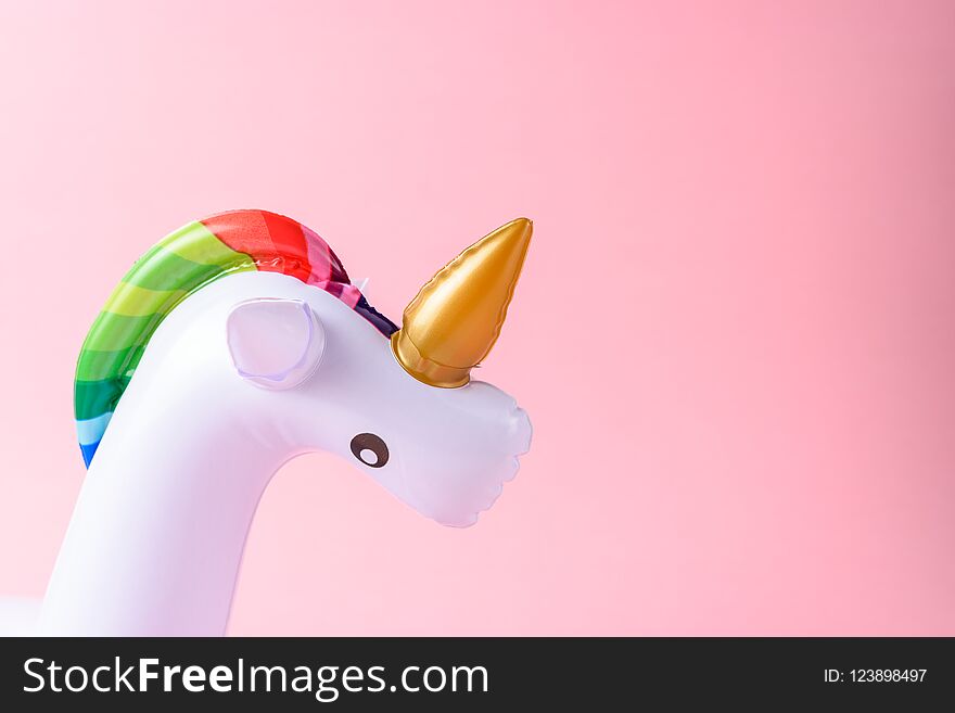 Inflatable Unicorn Pool Toy On Pink Background.