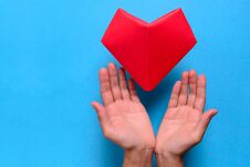 Heart Health Or Valentine`s Day Concept. Hands Holding Red Paper Heart. Origami. Stock Photography