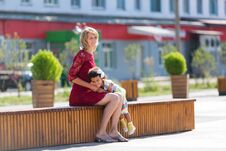 Caucasian Woman With Black Girl Sitting On A Bench. Royalty Free Stock Photo Caucasian Woman With Black Girl Sitting On A Bench. Royalty Free Stock Photo