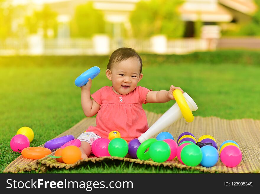 Cute Asian baby playing with toys and smile in playground. Cute Asian baby playing with toys and smile in playground