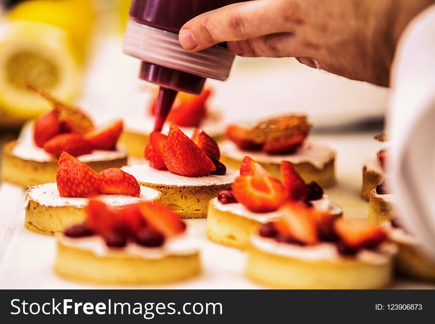 The Chef In The Kitchen Prepares Strawberry Desser