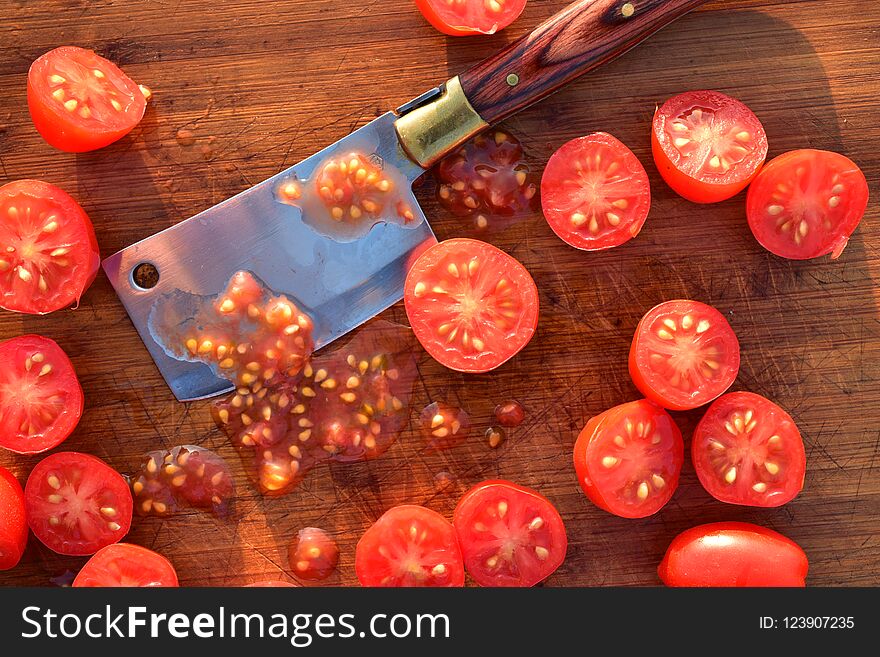 Cut grape tomatoes on wood cutting board