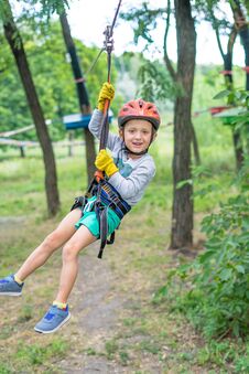 A Little Happy And Smiling Rock Climber Tie A Knot On A Rope. A Person Is Preparing For The Ascent. The Child Learns To Tie A Knot Stock Photography