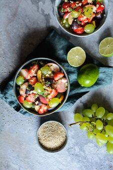 Fruit Salad With Quinoa, Strawberry, Peach, White Grapes, Plums, Mint And Honey Lime Dressing Stock Photos