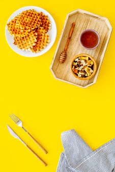 Round Belgian Waffles For Breakfast. Breakfast In Bed. Waffles On Plate. Honey And Dried Fruits In Tray, Knife And Fork Royalty Free Stock Photo Round Belgian Waffles For Breakfast. Breakfast In Bed. Waffles On Plate. Honey And Dried Fruits In Tray, Knife And Fork Royalty Free Stock Photo