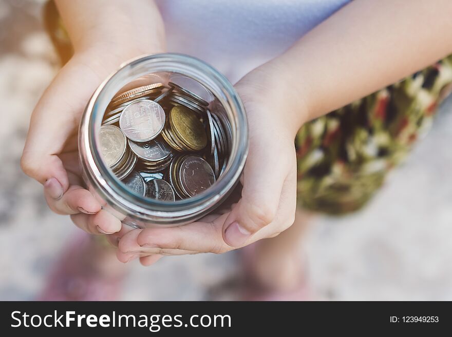 Small kid hands holding coins