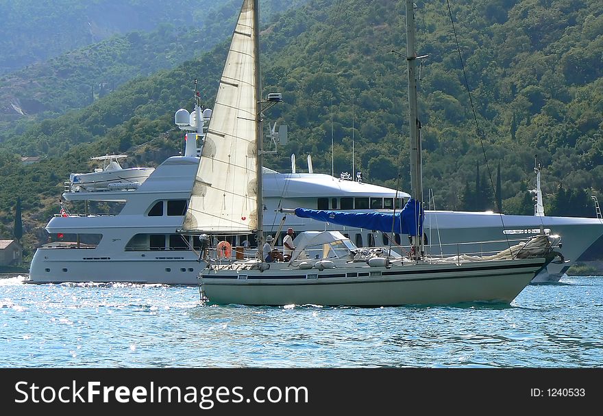 Yacht and boat passing by. Yacht and boat passing by