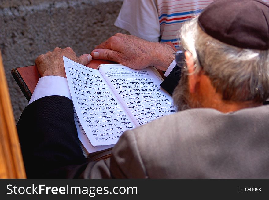 An Older Man Praying Open Book