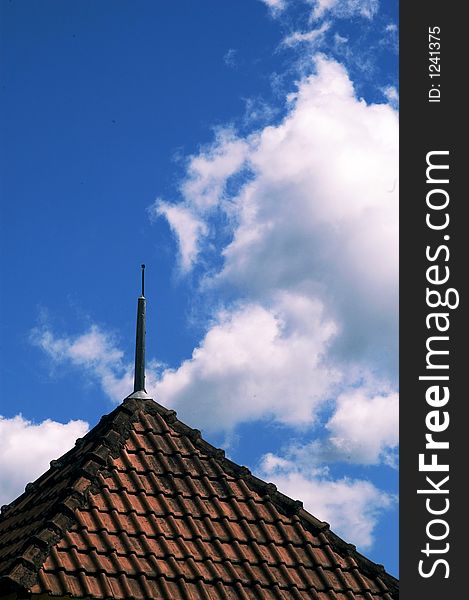 Old roof and tiles and white clouds on blue sky. Old roof and tiles and white clouds on blue sky