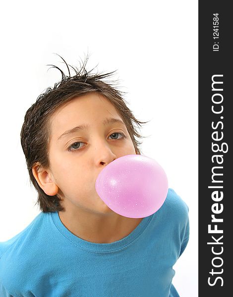 Boy blowing a pink bubble gum