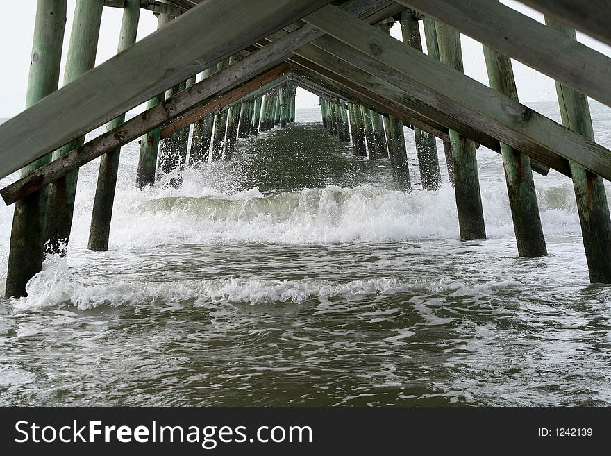 Waves crashing underneath the pier. Waves crashing underneath the pier