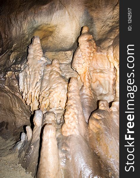 Stalactites on the side of cave wall.