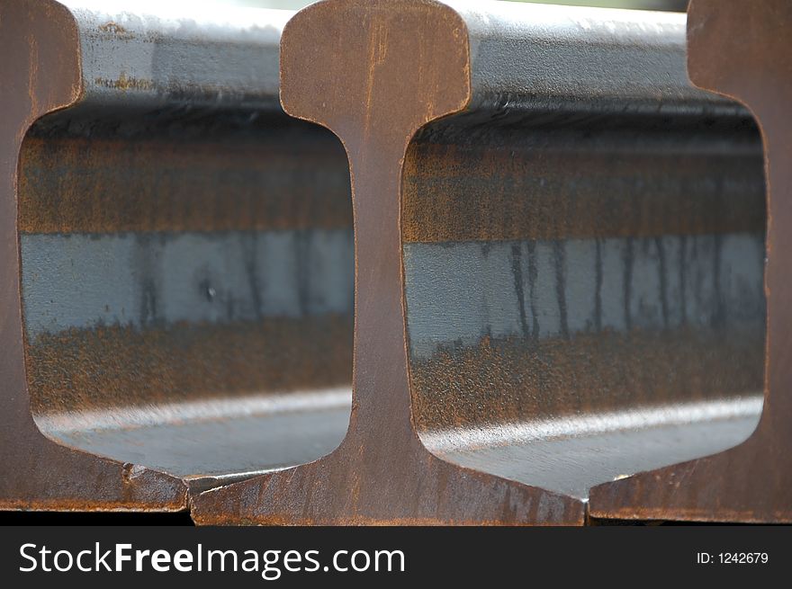 Close-up shot of a stockpile of Railway Rail taken at sunrise. Close-up shot of a stockpile of Railway Rail taken at sunrise.