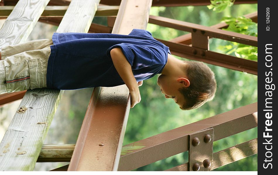 Boy Looking Over Bridge