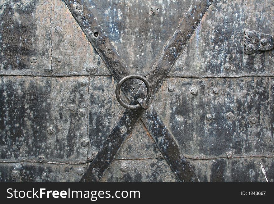 Detail from an old black door with X sign on it. Detail from an old black door with X sign on it