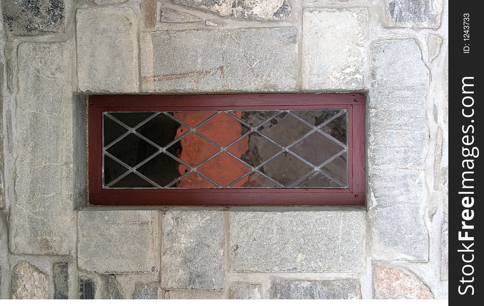 Stained window and stone wall