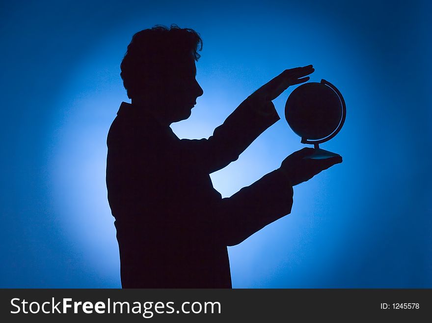 Silhouette of man with globe