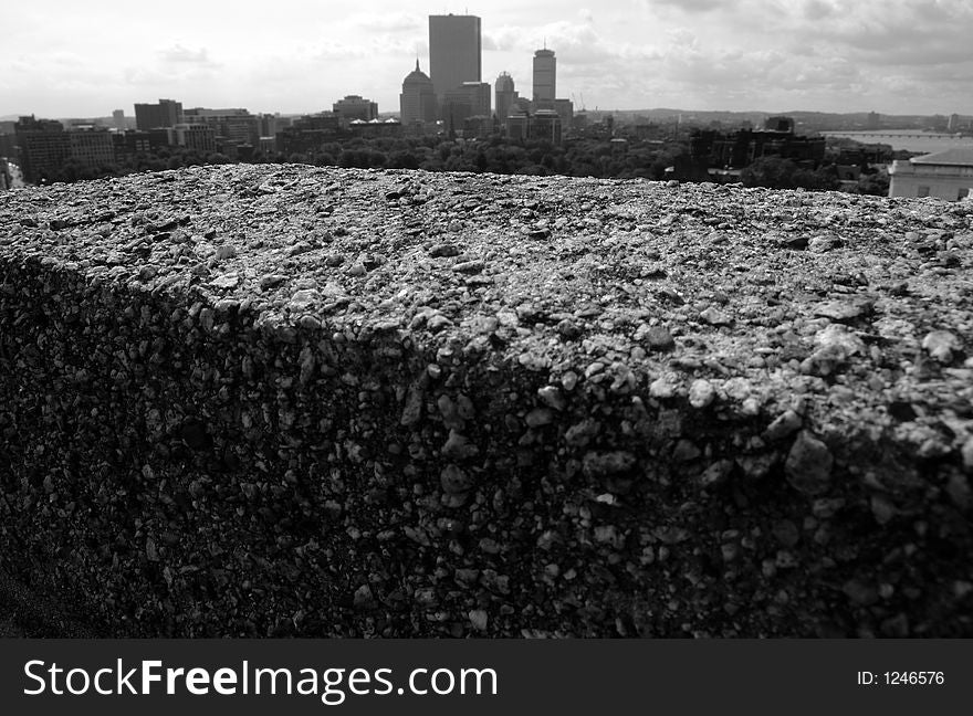 Cement slab on roof top with boston skyline in background, black and white. Cement slab on roof top with boston skyline in background, black and white