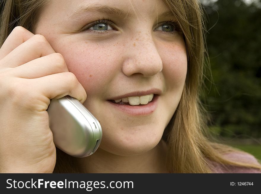 Teenage girl using cellphone outdoors