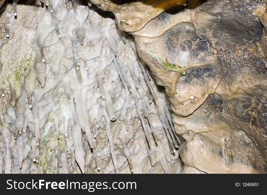 Stalagmites hanging from a cave roof.