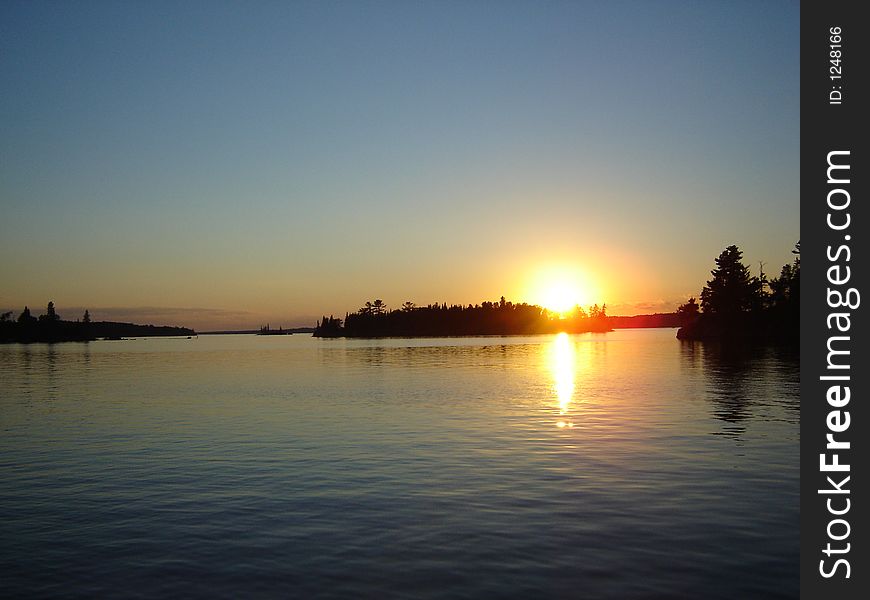 A smooth shot of the setting sun on the lake. A smooth shot of the setting sun on the lake.