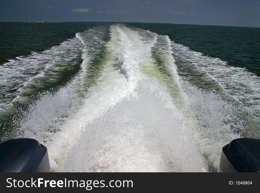 The wake of a speedboat and the north end of Captiva Island. The wake of a speedboat and the north end of Captiva Island