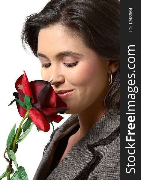 Woman smelling rose and looking at the rose