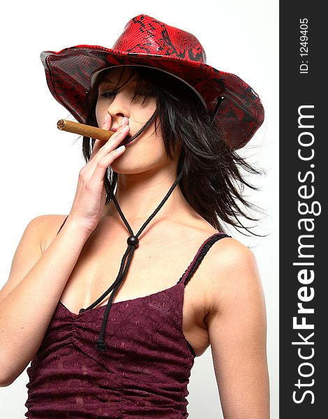 Woman wearing coyboy hat smoking a cigar with dark eyes. Woman wearing coyboy hat smoking a cigar with dark eyes