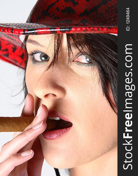 Woman wearing coyboy hat smoking a cigar. Woman wearing coyboy hat smoking a cigar