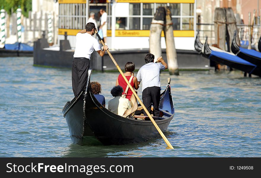 Part of the make-up of Venice are the Gondolas and the Gondaliers. Seen here ferrying people across the Grand Canal. Part of the make-up of Venice are the Gondolas and the Gondaliers. Seen here ferrying people across the Grand Canal.