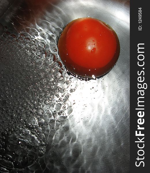 Tomato in water, close up. Tomato in water, close up