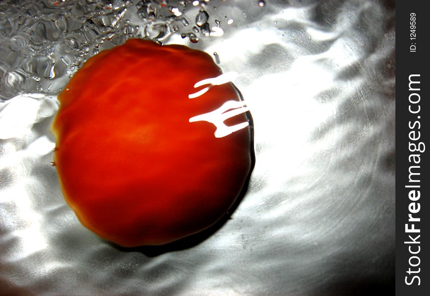 Tomato in water, close up. Tomato in water, close up