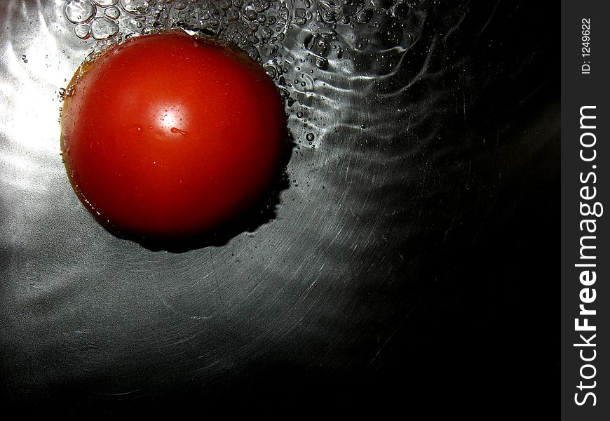 Tomato in water, close up. Tomato in water, close up