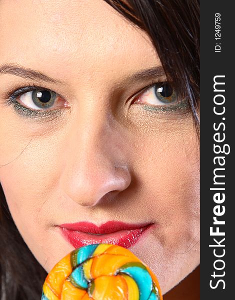 Dark hair woman with multi-coloured lollipop. Dark hair woman with multi-coloured lollipop