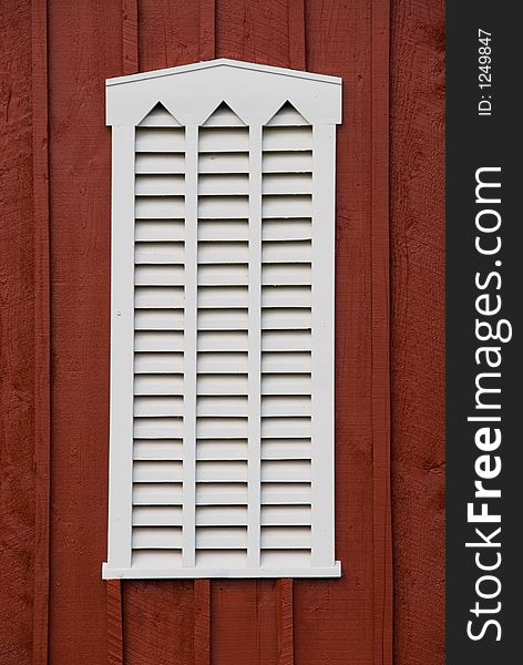 Handcfafted louvered window on a barn. Handcfafted louvered window on a barn