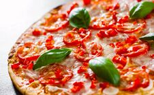 Pizza With Mozzarella Cheese, Ham, Tomatoes, Pepper, Spices And Fresh Basil. Italian Pizza On Wooden Royalty Free Stock Images Pizza With Mozzarella Cheese, Ham, Tomatoes, Pepper, Spices And Fresh Basil. Italian Pizza On Wooden Royalty Free Stock Images