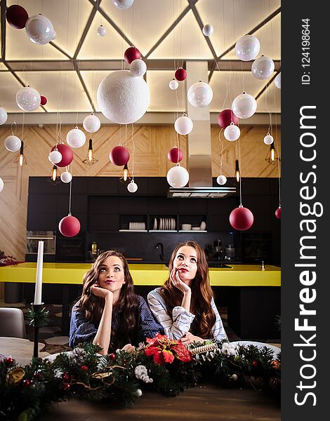 Pretty Twins Young Women Together In A Kitchen Room, Casual Home Style, New Year Christmas Decorations