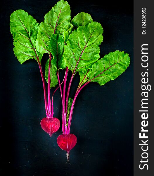 Beetroot cut in half on a dark background, place for text. Beetroot cut in half on a dark background, place for text