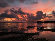 Dawn Above Pacific Ocean Seen From Reef On Beach In Kapaa On Kauai Island, Hawaii. Stock Photos