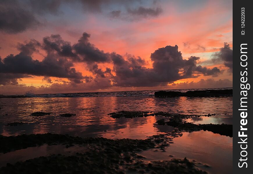 Dawn above Pacific Ocean Seen from Reef on Beach in Kapaa on Kauai Island, Hawaii.