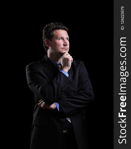 Successful businessman on a dark background.photo with copy space