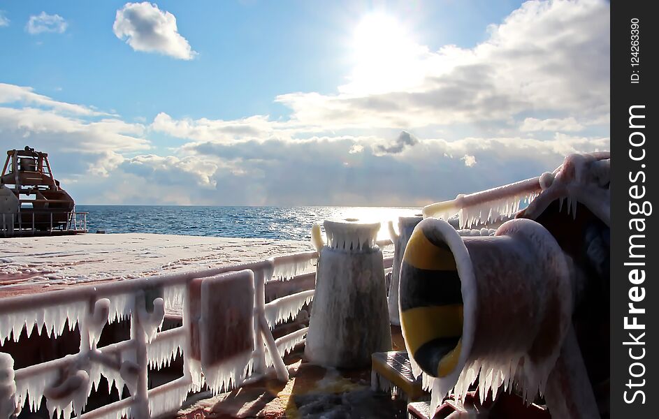 Ice of the ship and ship structures after swimming in frosty weather during a storm in the Pacific Ocean. Ice patterns and icicles, the play of light, ice and sun.