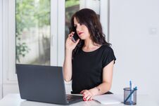 Cute Business Woman At Office Talking On The Mobile Phone And Working On Laptop Stock Photo Cute Business Woman At Office Talking On The Mobile Phone And Working On Laptop Stock Photo