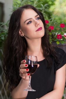 Young Beautiful Girl Holding Glass With Red Wine And Relaxing In Garden Royalty Free Stock Images Young Beautiful Girl Holding Glass With Red Wine And Relaxing In Garden Royalty Free Stock Images