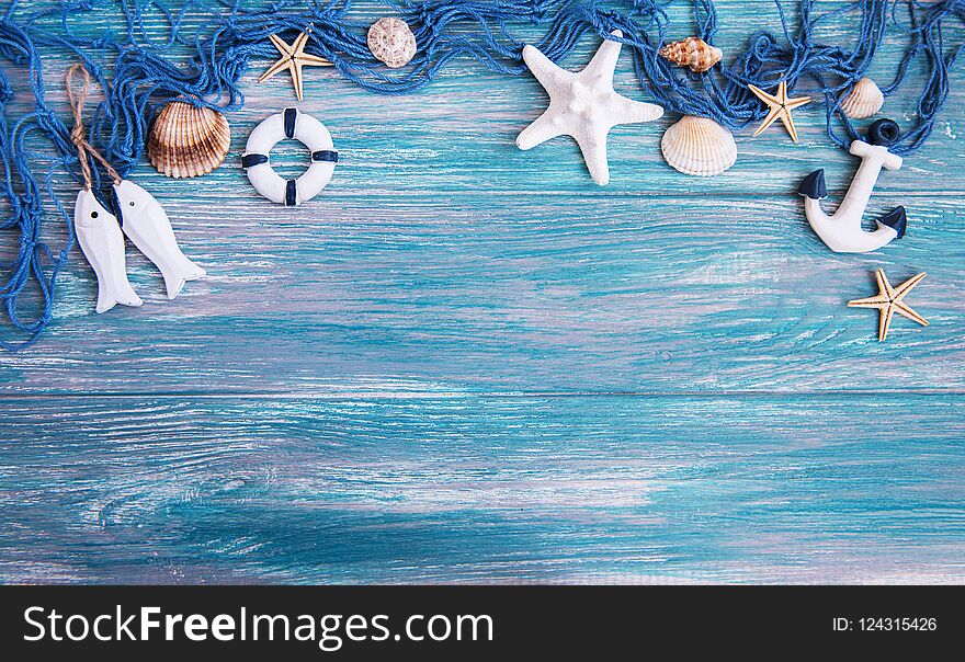 Fishing net with starfish on a wooden background