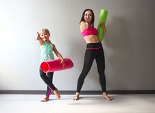 Young Woman Having Fun With Kid After Yoga Royalty Free Stock Photos
