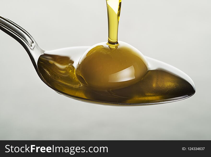 Olive Oil Pouring To Spoon