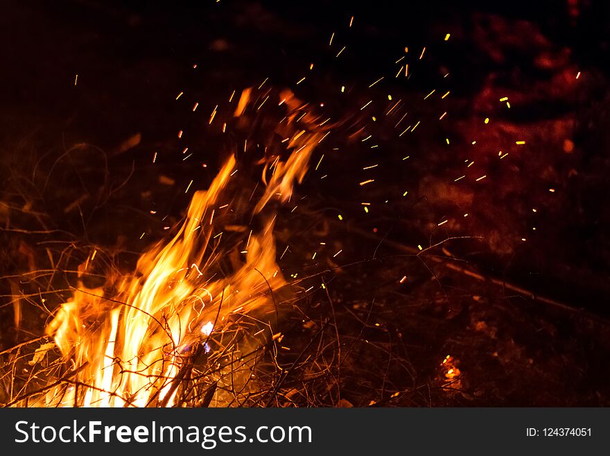 Night bonfire with sparks motion blur. Fire background with copyspace. Night bonfire with sparks motion blur. Fire background with copyspace